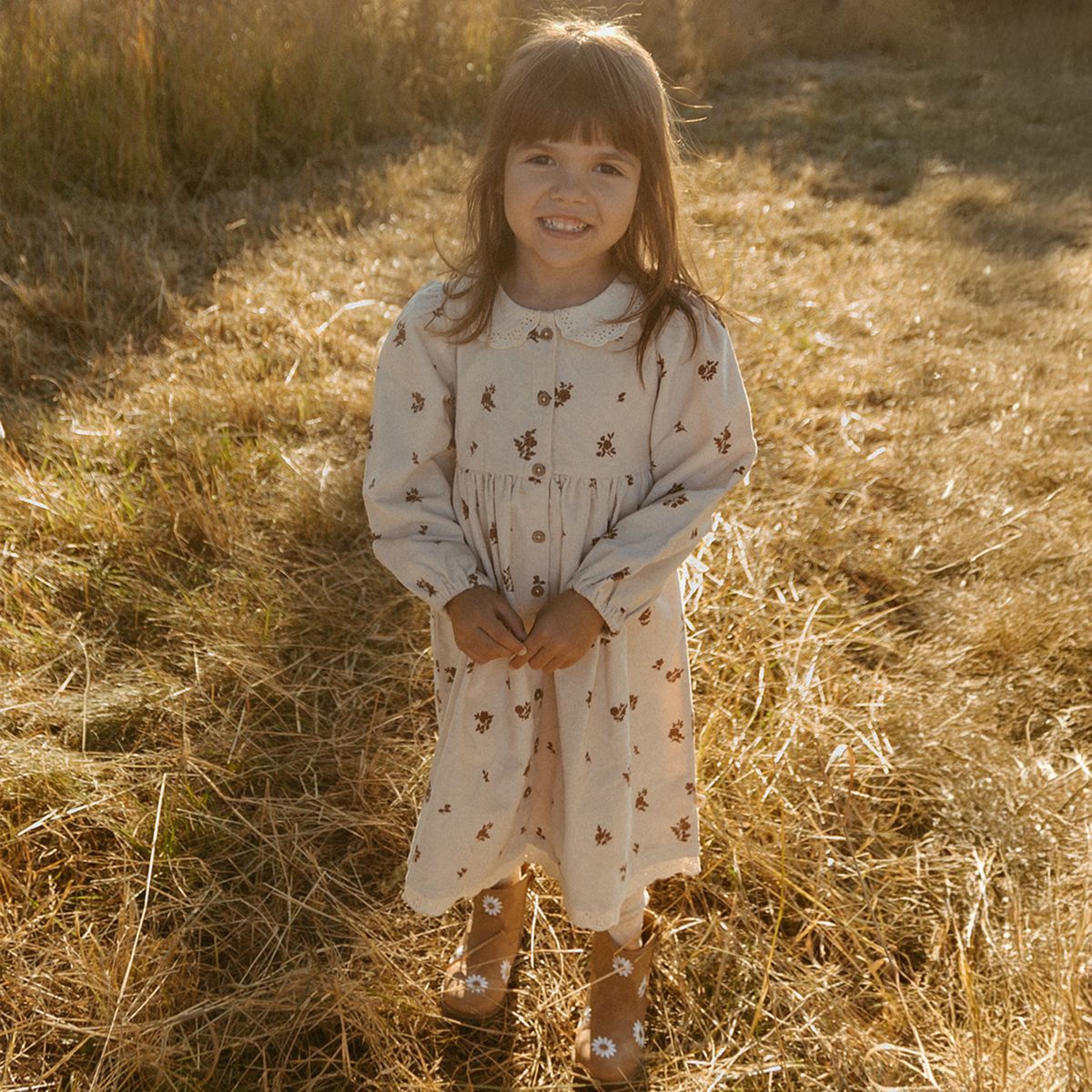Adorable brown floral corduroy dress with collar and button closure for baby girls