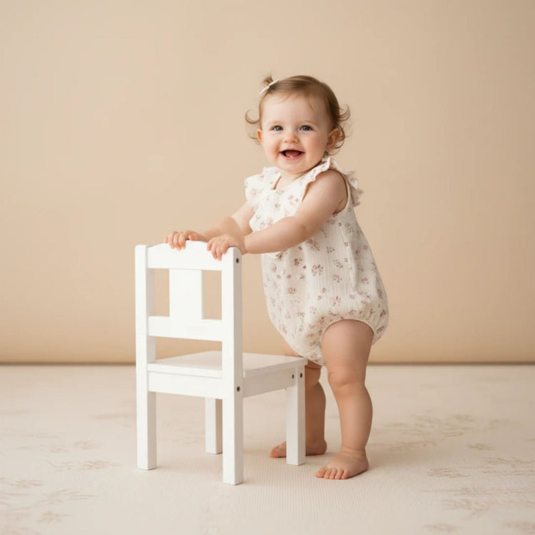 Organic Cotton Sleeveless Ruffle Bubble Romper - Blush Floral, full romper flat lay on white background showing bubble silhouette and blush floral pattern