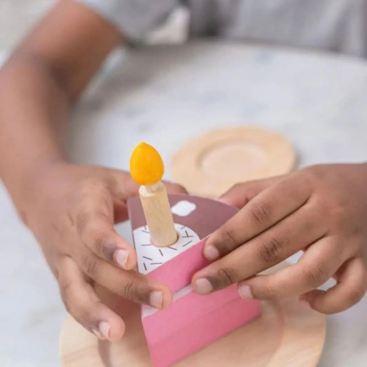 
                    
                      PlanToys Birthday Cake Set, wooden play cake with six slices, candles, knife, and chocolate bar nameplate on a white background
                    
                  