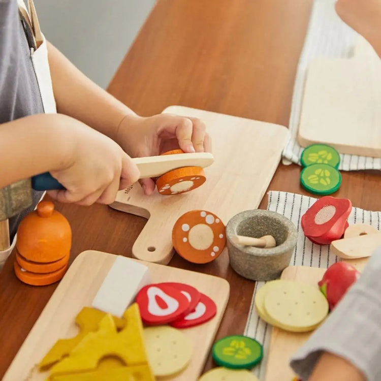 
                    
                      PlanToys Cheese & Charcuterie Board, wooden play set with brie, gouda, salami, crackers, and cutting board on a white background
                    
                  