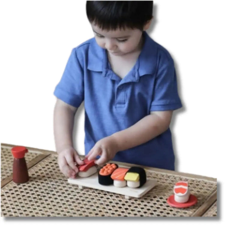 
                    
                      PlanToys Sushi Set, wooden play set with salmon, tuna, tamago, shrimp, roe, tray, and shoyu bottle on a white background
                    
                  
