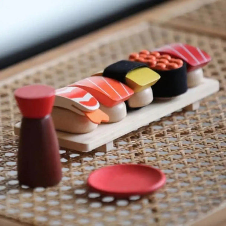 PlanToys Sushi Set, wooden play set with salmon, tuna, tamago, shrimp, roe, tray, and shoyu bottle on a white background