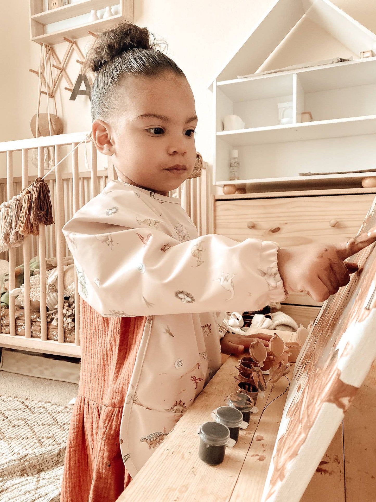 Adjustable neckline on Dinosaur Print Smock Bib