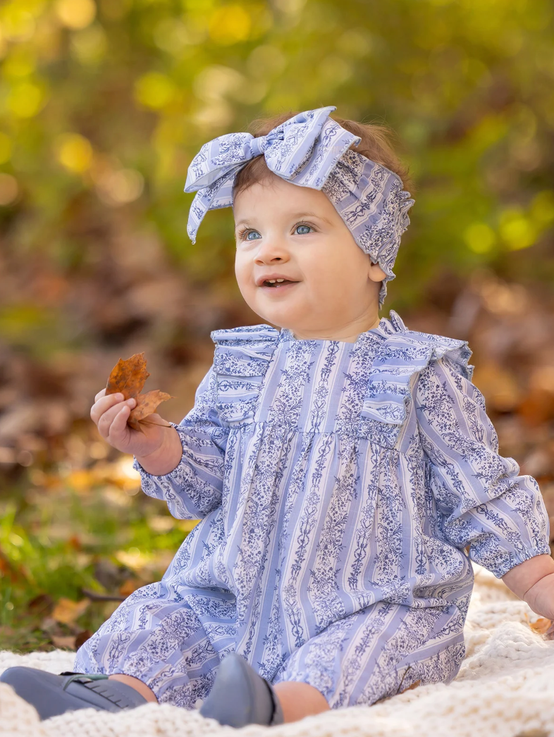Crawling baby in baby blue romper & headband set ready for play