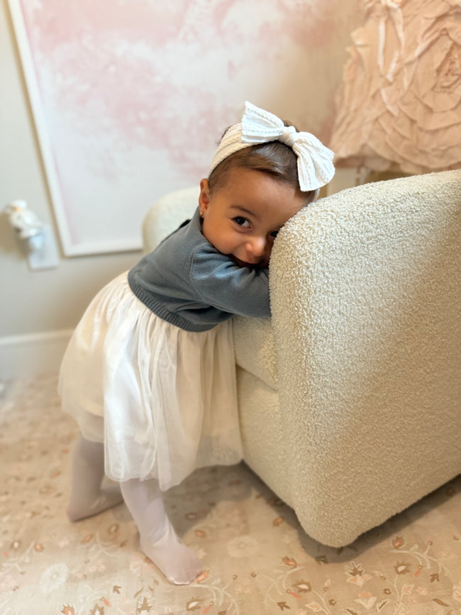 Baby girl wearing blues baby sweater dress