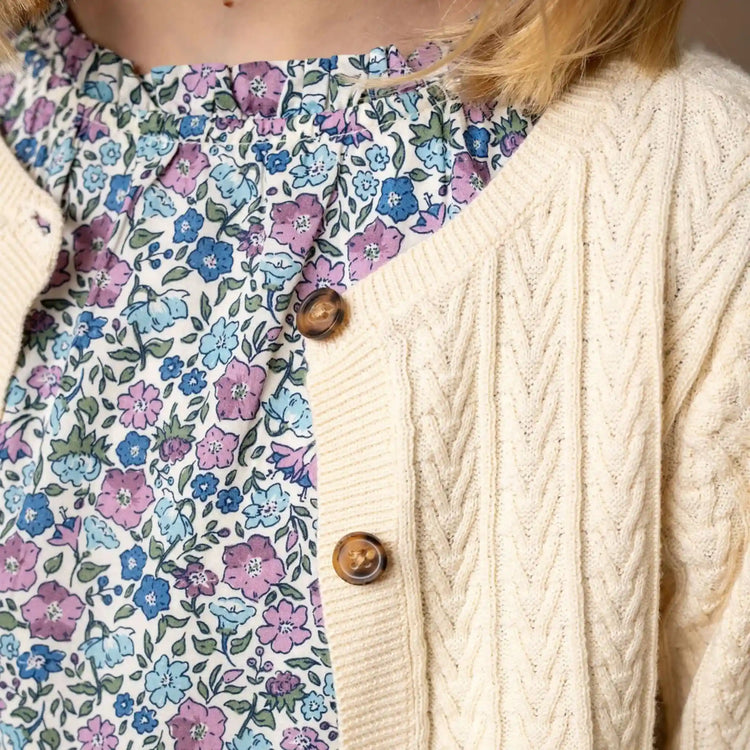 Organic Baby Cable Cardigan– Baby shown as a classic organic cable knit cardigan for baby girls