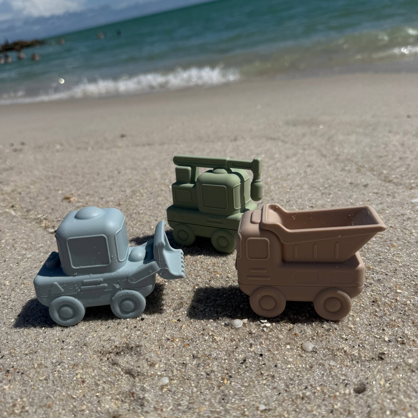 Three-piece silicone construction vehicles bath toy set including dump truck, cement mixer, and excavator