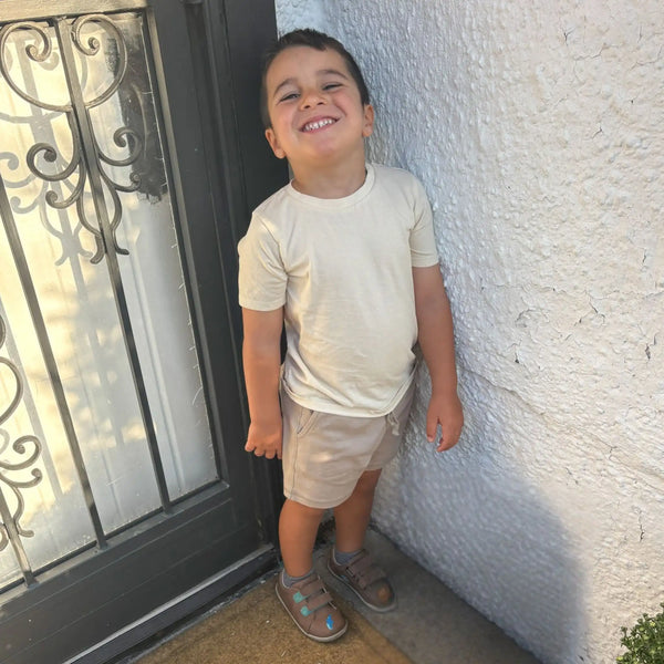 Con Tee & Short Set (Organic Cotton) shown as a neutral boys outfit with t-shirt and beige drawstring shorts
