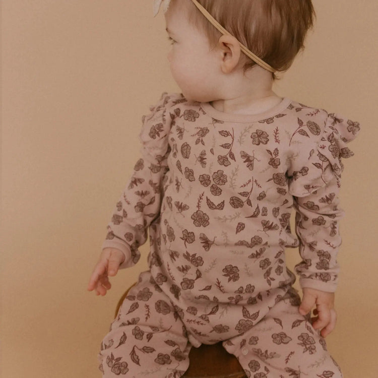 Organic Cotton Floral Ruffle Long Sleeve Romper showing ruffle detail and GOTS-certified organic cotton fabric
