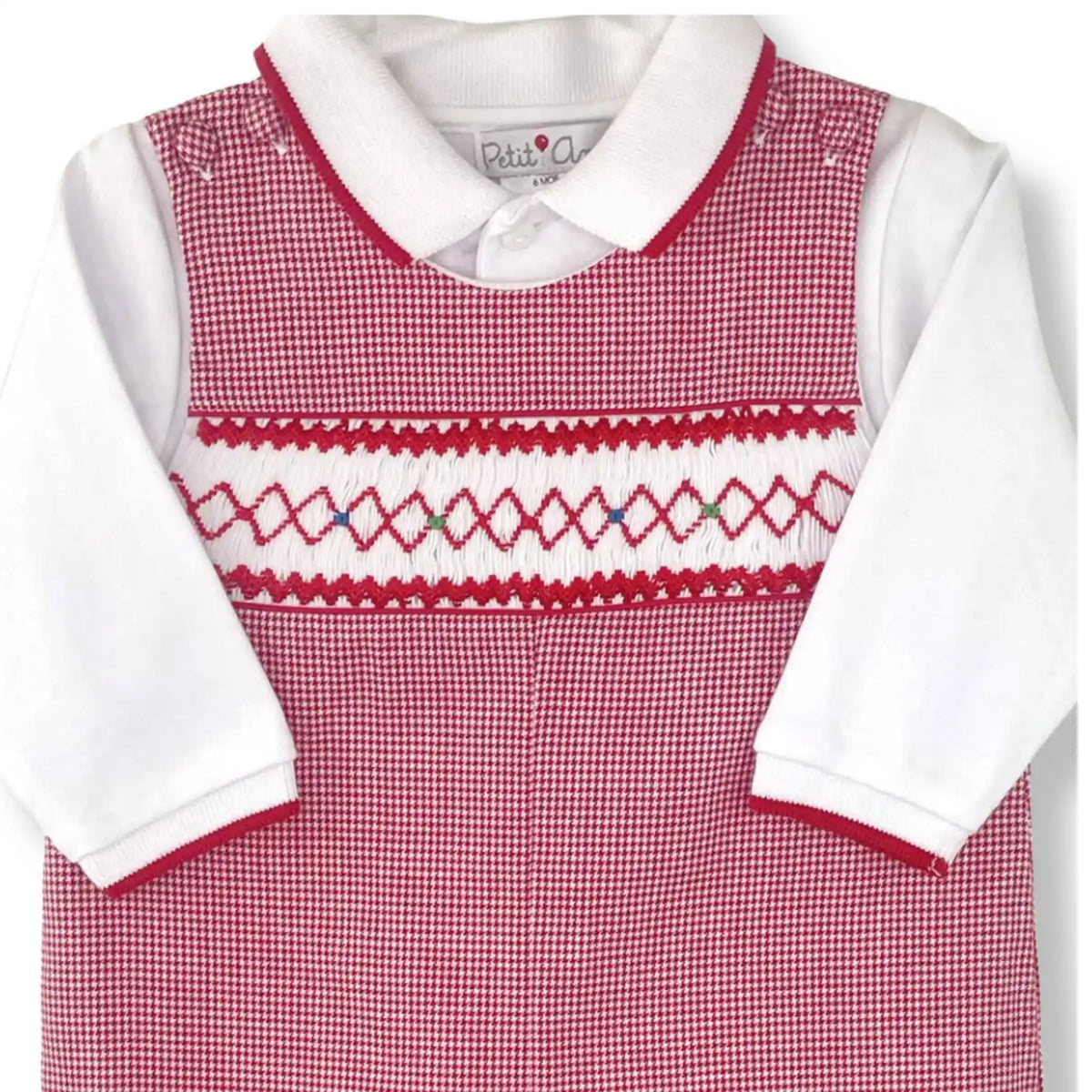 A baby's short-sleeve romper in a red and white gingham pattern, featuring a white Peter Pan collar, white long sleeves, and red and white embroidered detailing across the chest.