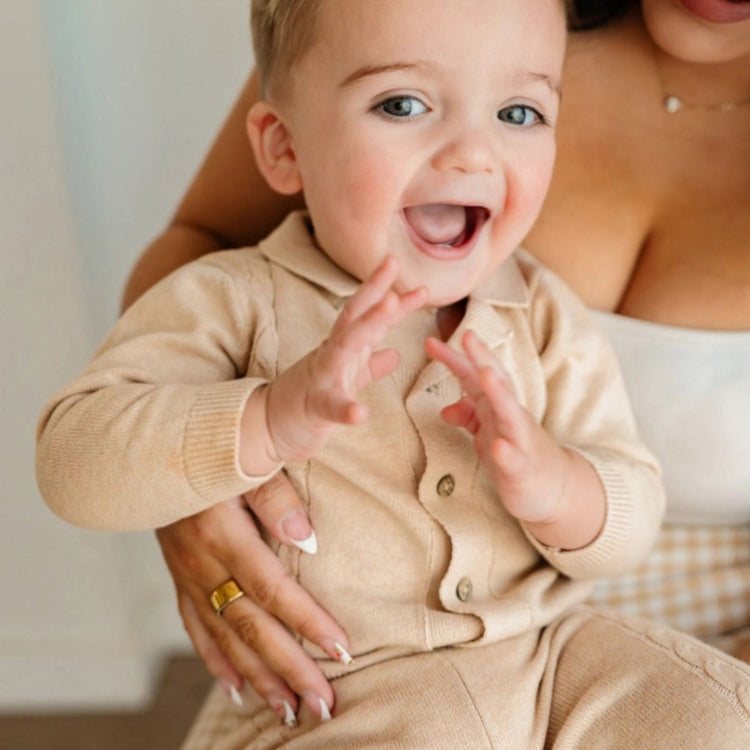 
                    
                      Resort Cable Knit Baby Sweater Cardigan & Pant Set, Viverano Organics organic cotton cable knit cardigan with matching pants on baby
                    
                  